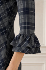 Close-up of the tiered ruffle cuff detail of the Aspiga Elizabeth Check Dress in Blue/Grey