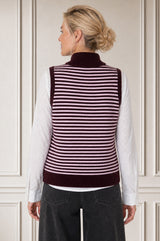 Model wearing the Aspiga Merino Wool Stripe Zip Through Gilet in Burgundy/Pink, back view