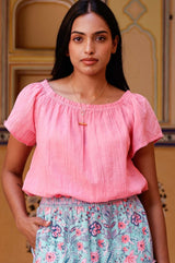 Ilana pink cotton top with elasticated neckline and hemline styled with Aspiga accessories and Aspiga's Beck skirt