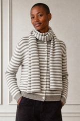 Model wearing the Aspiga Merino Wool Button Through Stripe Cardigan in Taupe/Cream with a matching striped scarf, full-length front view