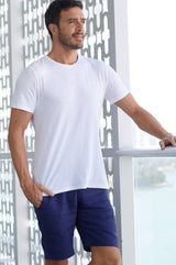Man wearing navy linen tailored shorts, paired with a white t-shirt.