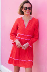 Short red Purdie Dress red with V neckline with pink ric rac detailing around the frill cuffs and waistband