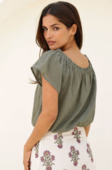 Khaki Ilana cotton short sleeve top with shirred neckline and elasticated neckline and hem styled with Aspiga antique block print cream skirt showing the back