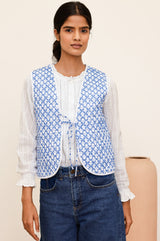 Arlo quilted jacket with a flower stamp in cornflower blue and white with a white border and tie front