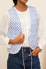 Arlo quilted jacket with a flower stamp in cornflower blue and white with a white border and tie front undone