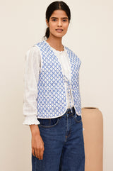 Arlo quilted jacket with a flower stamp in cornflower blue and white with a white border and tie front