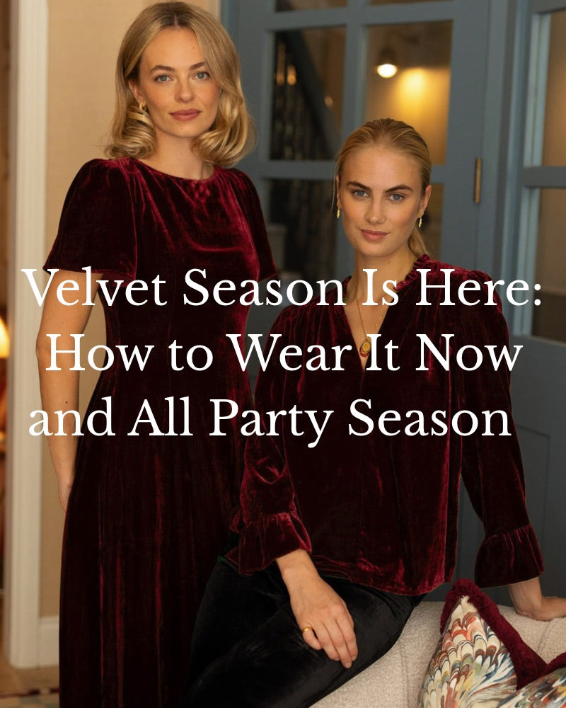 Two women wearing Aspiga wine red velvet, a short sleeve midi dress and a ruffle cuff blouse with black velvet trousers