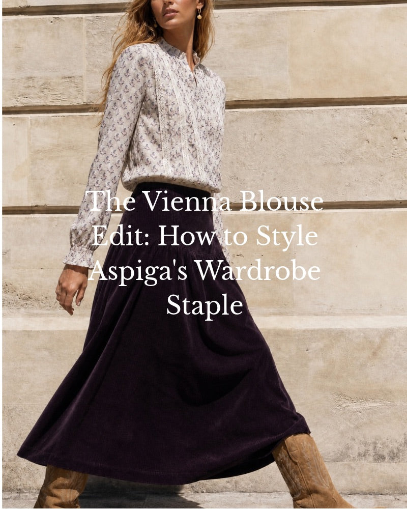 The Vienna Blouse Edit: How to Style Aspiga’s Wardrobe Staple. A woman wearing a cream printed Vienna blouse with lace trim, a dark plum cord midi skirt and tan western boots.