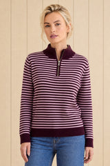 Model wearing the Aspiga Merino Wool Stripe Quarter Zip Jumper in Burgundy/Pink, a striped quarter-zip jumper, front view