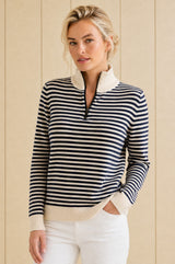 Model wearing the Aspiga Merino Wool Stripe Quarter Zip Jumper in Off White/Navy, a breton-striped quarter-zip jumper, front view