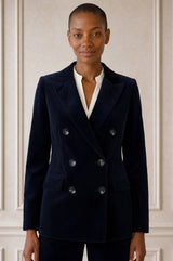 Model wearing the Aspiga Double Breasted Corduroy Blazer in Deep Navy, a tailored corduroy blazer with a peak lapel and double-breasted button front, front view