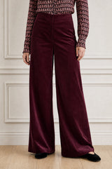 Model wearing the Aspiga Wide Leg Stretch Corduroy Trouser in Burgundy, a high-waisted wide-leg velvet corduroy trouser, front view
