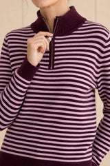 Model wearing the Aspiga Merino Wool Stripe Quarter Zip Jumper in Burgundy/Pink, a striped quarter-zip jumper, alternate view