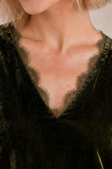 Close-up of the scalloped lace-trimmed V-neckline of the Aspiga Claudette Velvet Blouse in Dark Olive