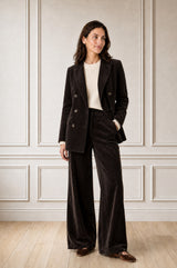 Model wearing the Aspiga Double Breasted Corduroy Blazer in Chocolate Brown, a tailored corduroy blazer with a peak lapel and double-breasted button front, alternate view