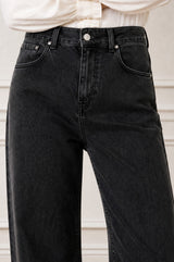 Close-up of the front pocket and rivet detail of the Aspiga Relaxed Straight Denim Jean in Black