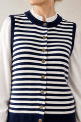 Model wearing the Aspiga Merino Wool Stripe Button Knit Gilet in Navy/Off White, a breton-striped button-front knit gilet, alternate view