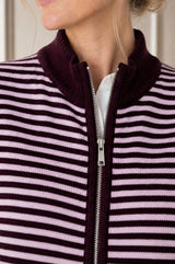 Close-up of the zip and collar detail of the Aspiga Merino Wool Stripe Zip Through Gilet in Burgundy/Pink
