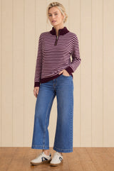 Model wearing the Aspiga Merino Wool Stripe Quarter Zip Jumper in Burgundy/Pink, a striped quarter-zip jumper, alternate view