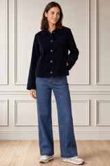 Model wearing the Aspiga Corduroy Collared Jacket in Deep Navy with jeans, full-length front view, smiling