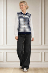 Model wearing the Aspiga Merino Wool Stripe Button Knit Gilet in Navy/Off White, a breton-striped button-front knit gilet, alternate view