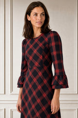 Model wearing the Aspiga Elizabeth Check Dress in Red/Blue with black shoes, back view