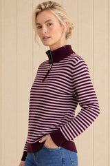 Model wearing the Aspiga Merino Wool Stripe Quarter Zip Jumper in Burgundy/Pink, a striped quarter-zip jumper, alternate view
