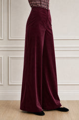 Model wearing the Aspiga Wide Leg Stretch Corduroy Trouser in Burgundy, a high-waisted wide-leg velvet corduroy trouser, alternate view