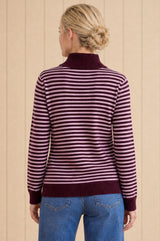 Additional styled photo of a model wearing the Aspiga Merino Wool Stripe Quarter Zip Jumper in Burgundy/Pink, a striped quarter-zip jumper