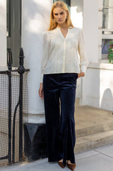 Model wearing the Aspiga Rosemary Lace Front Blouse in Cream tucked into navy corduroy trousers with brown heels, full-length front view
