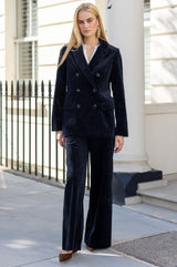 Model wearing the Aspiga Wide Leg Chunky Corduroy Trouser in Deep Navy with a matching double-breasted blazer, full-length front view