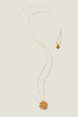 Product photo of the Aspiga Riviera Necklace, a gold necklace with a round sun-motif pendant surrounded by multicolour beads