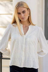 Close-up of the lace front detail of the Aspiga Rosemary Lace Front Blouse in Cream, pearl earrings