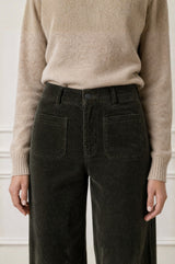 Model wearing the Aspiga Stretch Corduroy Trouser in Khaki, a wide-leg corduroy trouser with patch pockets, alternate view