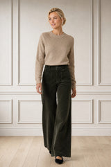 Model wearing the Aspiga Stretch Corduroy Trouser in Khaki, a wide-leg corduroy trouser with patch pockets, alternate view