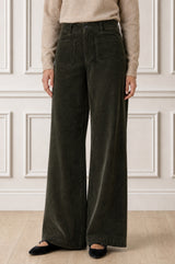 Model wearing the Aspiga Stretch Corduroy Trouser in Khaki, a wide-leg corduroy trouser with patch pockets, front view
