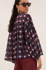 Back view of a model wearing the Aspiga Mine Ikat Blouse in Wine, sunglasses and gathered sleeve detail