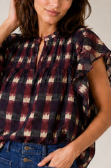 Close-up of the Aspiga Danee Ikat Blouse in Wine, showing the ruffle sleeve and V-neck detail