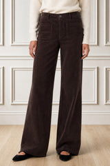 Model wearing the Aspiga Stretch Corduroy Trouser in Chocolate, a wide-leg corduroy trouser with patch pockets, front view