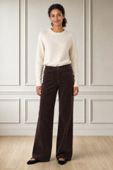 Model wearing the Aspiga Stretch Corduroy Trouser in Chocolate, a wide-leg corduroy trouser with patch pockets, alternate view