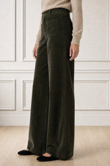 Model wearing the Aspiga Stretch Corduroy Trouser in Khaki, a wide-leg corduroy trouser with patch pockets, alternate view