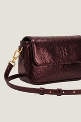 Close-up product photo of the Aspiga Jude Metallic Bag in Copper, showing strap and clasp detail