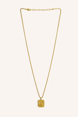 Product photo of the Aspiga Sev Necklace in Gold, a fine gold-tone chain necklace with a sun-embossed square pendant