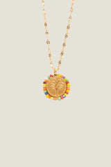 Close-up of the palm tree pendant and multicolour beaded surround of the Aspiga Tuti Frutti Necklace
